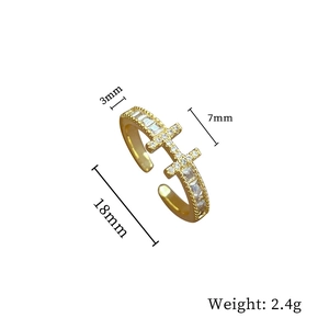 Detailed view of the double cross design golden ring with sparkling cubic zirconia