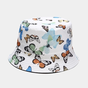 Detail of white cotton bucket hat featuring vibrant colorful butterfly patterns and stitching