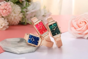 Detailed macro view of stylish rectangular quartz watches with rose gold mesh bands