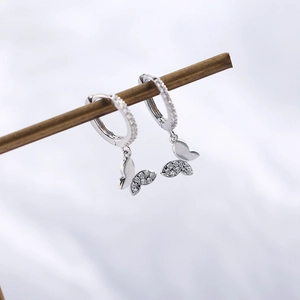 Detailed macro view of S925 sterling silver hoop earrings with diamond butterfly pendant