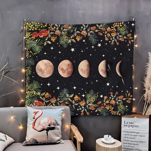Detail of moon phase tapestry with vintage floral patterns and cozy fairy light decor