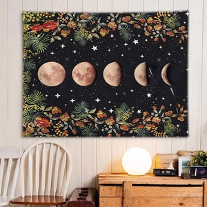 Detail of lunar cycle wall tapestry with stars and floral border in home interior