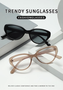 Detailed view of trendy oval cat-eye sunglasses and champagne optical frames on props