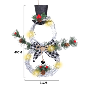 Detail view of snowman Christmas wreath with LED lights, pine cones, measuring 40x21cm