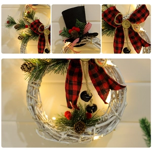 Christmas wreath with LED lights, plaid bow, pine needles and cones on white rattan