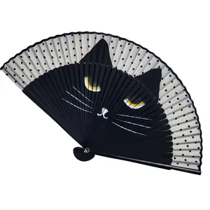 Close-up of a black cat face design and polka dots on a Japanese-style folding fan