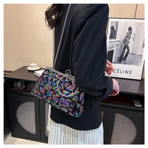 Detail of colorful geometric sequin clutch with silver metal ring handle and clip closure