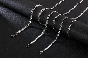 Detailed view of silver stainless steel Cuban link chains with lobster clasps