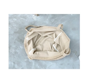 Interior view of beige corduroy tote bag showing spacious storage and reinforced seams