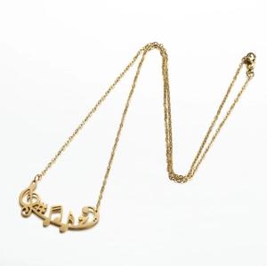 Golden musical note pendant necklace for women featuring a minimalist treble clef design