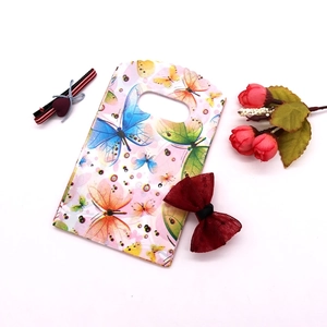 Macro view of mini plastic jewelry bag with colorful butterfly prints and cut-out handle