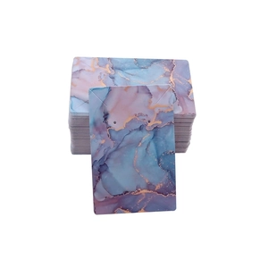 Macro view of marble textured jewelry display cards for earrings in gold and blue