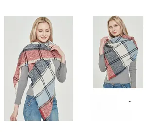 Close-up of multicolored plaid triangle scarf with frayed edges and thick woven texture