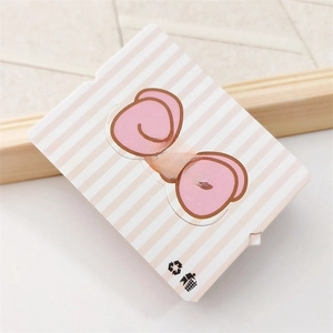 Detail of pink bow hair accessory on a pink and white striped card packaging
