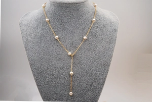 Detailed view of adjustable Y-shaped gold chain necklace with freshwater pearls on a bust