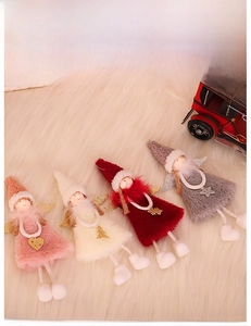 Detail of plush Christmas angel dolls in pink, white, red, and grey with glitter wings