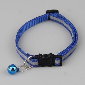 Detail of blue plaid pet collar with reflective strip, cat-shaped buckle and metal bell