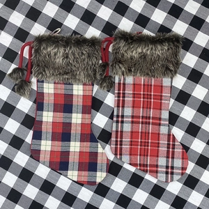 Classic plaid Christmas stockings with faux fur trim and pom-poms for holiday tree decor