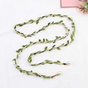 Detail of woven leaf belt with cotton rope, green foliage and pearl pendants