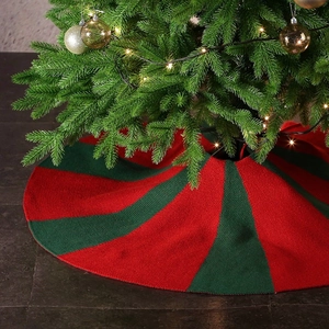 36-inch knitted Christmas tree skirt with festive red and green stripes in a cozy setup