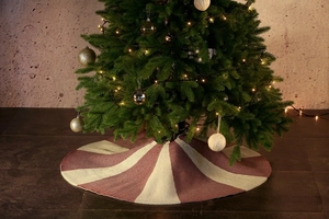 Close-up of red and white striped knitted Christmas tree skirt with festive texture