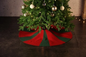 Detail of red and green striped knitted Christmas tree skirt with textured yarn finish
