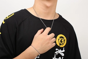 Close-up of model wearing double buckle stainless steel chain necklace and bracelet set