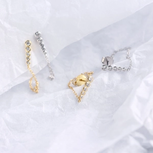 Macro shot of S925 sterling silver earrings showing the 925 hallmark stamp and zircon chain