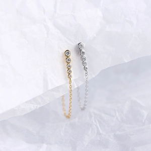 Macro detail of S925 sterling silver long chain earrings with vertical zircon row