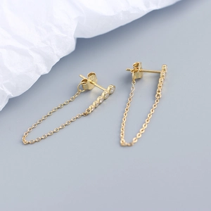 Detail showing S925 hallmark on gold plated sterling silver earrings with CZ tassels
