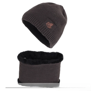 Close-up of winter knit beanie and snood set with thick faux lamb wool lining and maple leaf tag