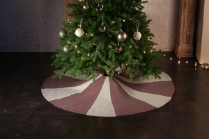 Detail of red and white knitted Christmas tree skirt with festive holiday decor
