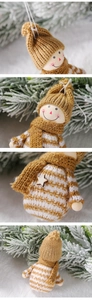 Detail of knitted snowman ornament with wood beads and star button on pine branch