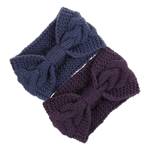 Detailed knit texture of navy and purple cable knit winter headbands in a flat lay view