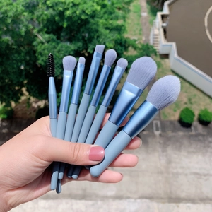 Set of 9 professional blue makeup brushes with soft grey bristles for face and eye makeup