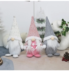 Close-up of three Nordic Christmas gnomes in pink, white, and grey with sequin hats