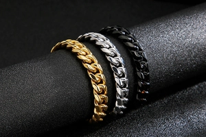 Macro shot of Cuban chain link rings in gold, silver, and black polished titanium steel