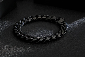 Detailed close-up of chunky black snake chain bracelet with polished link texture