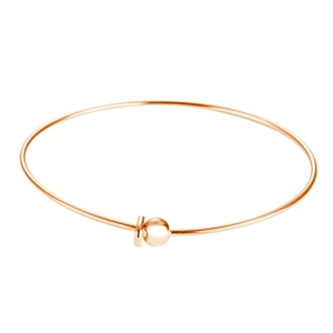 Close-up of rose gold minimalist open bangle with round beads and circular charm
