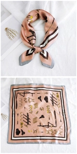 Close-up of pink square silk scarf with horse bit pattern and elegant grey border detail