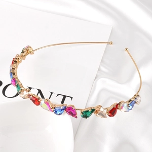 Detail of colorful water-drop rhinestones in claw setting on thin gold headband