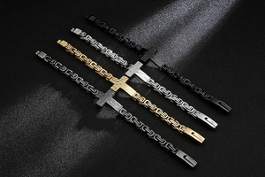 Macro view of woven titanium steel bracelets with cross charms in four metallic finishes