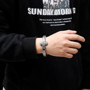 Retro punk cross bracelet in titanium steel with detailed floral engraving on male wrist