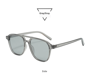 Side view detail of gray translucent pilot sunglasses with double bridge and metal rivets