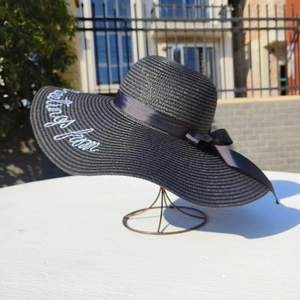 Black straw sun hat with white Greetings from embroidery and black ribbon bow for women