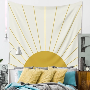 Detail of bohemian wall tapestry featuring a yellow sunburst pattern on white fabric