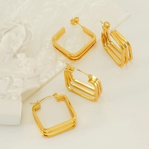 Polished gold geometric earrings set with layered square design and artistic display