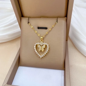 Elegant gold heart pendant necklace with shimmering crystals and butterfly detail