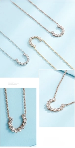 Detail view of horseshoe pendant necklaces with small crystals in three metallic tones