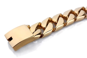 Detail of a polished golden stainless steel Cuban link bracelet with a secure square clasp